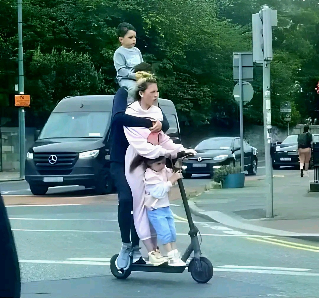 A family on a small scooter 