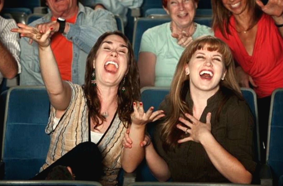 People laughing at a cinema hall 